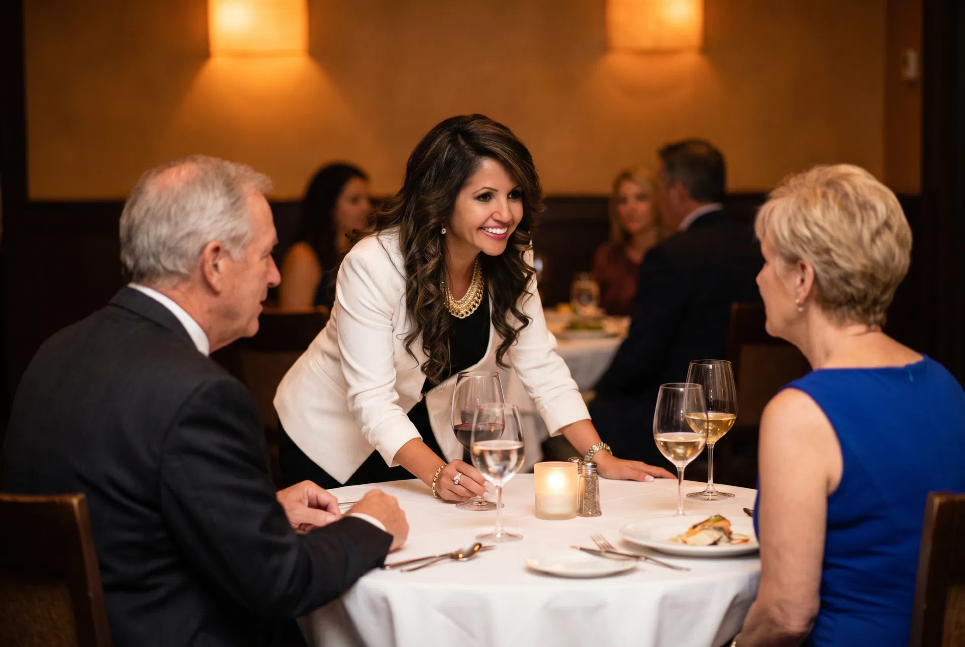 Alma Dubon consulting with guests at a Cornerstone dinner event