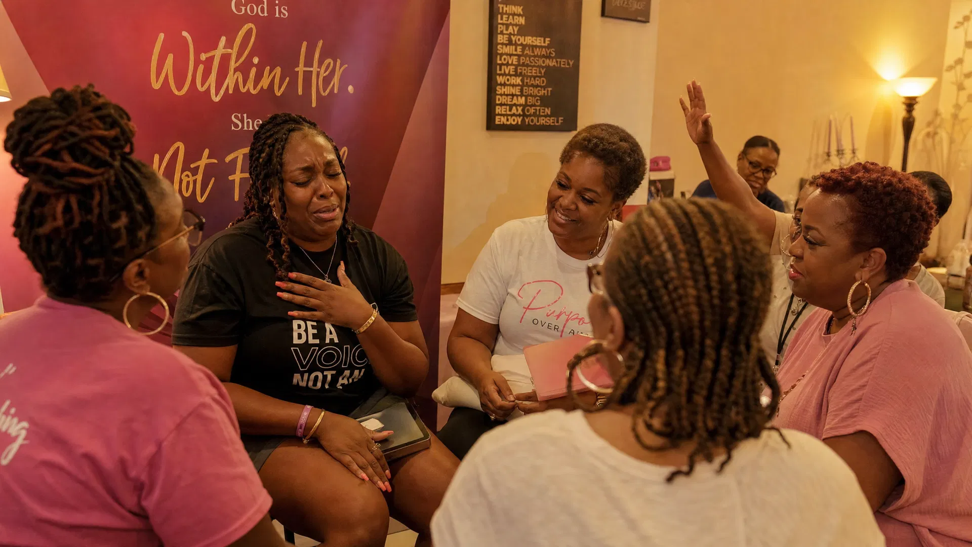 Women in a circle of prayer and testimony