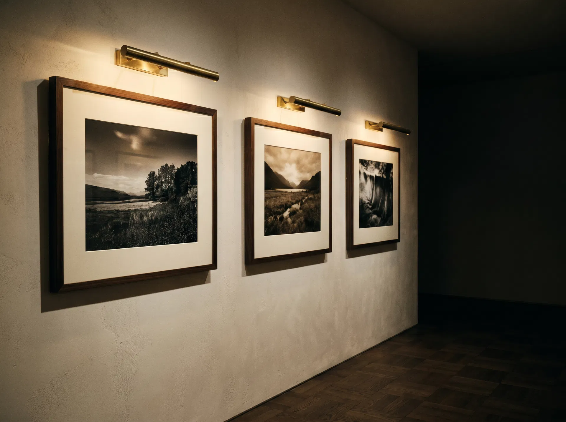 Inside the print gallery — framed photographs lit by warm picture lights
