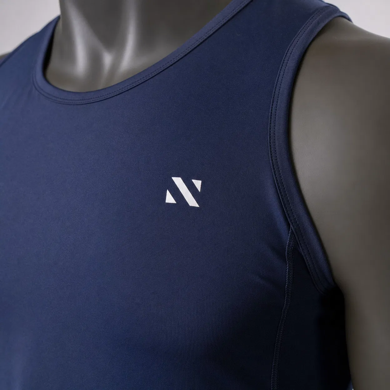 Close-up product photography showing navy fitness t-shirt fabric quality and stitching