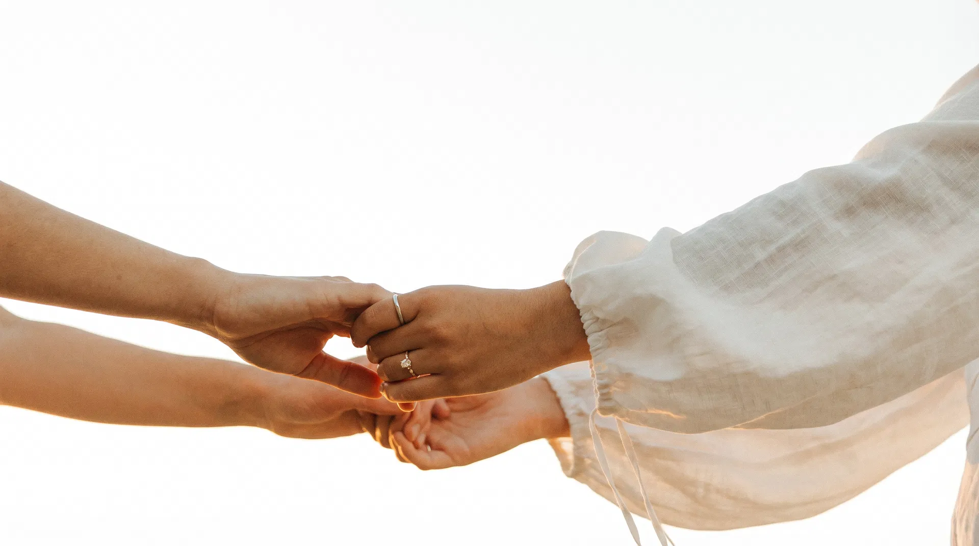 Two women holding hands — connection and trust