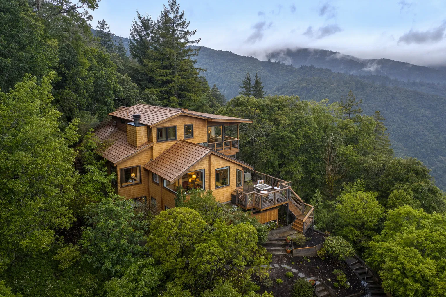 Beautiful wood-shingled home nestled among redwood trees in Marin County with freshly stained cedar shingles and multiple restored decks