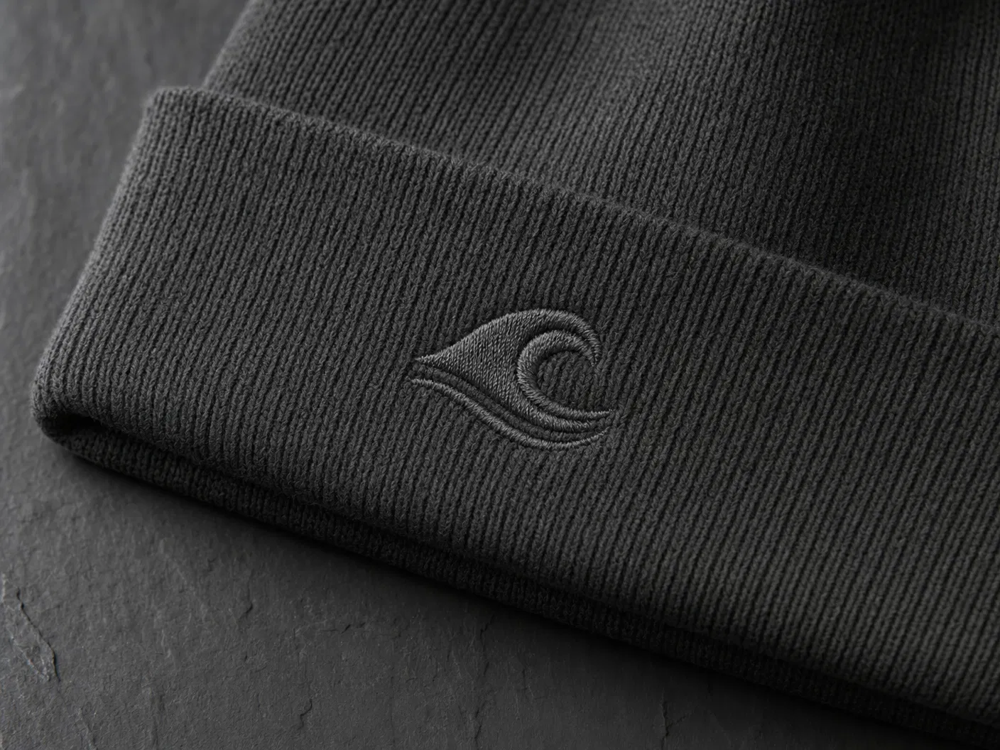 Tonal embroidery wave icon on charcoal beanie