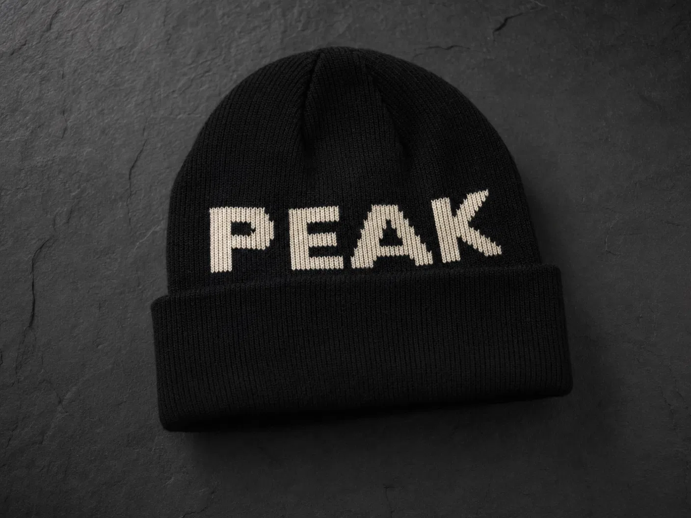 Black beanie with PEAK text knitted in cream jacquard