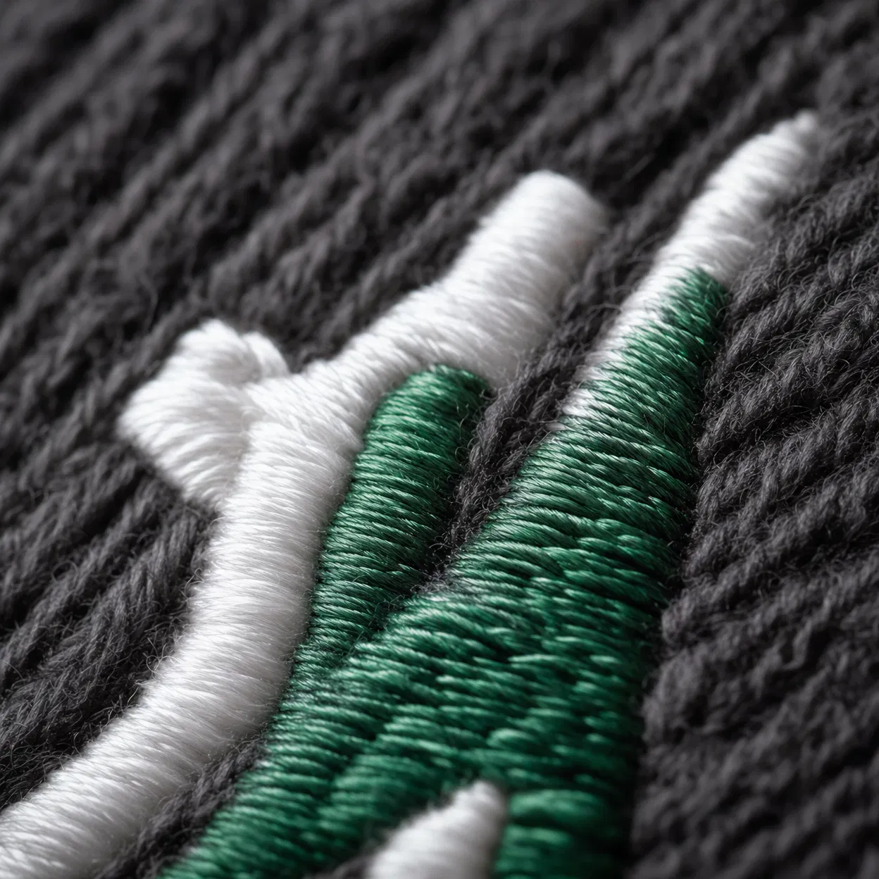 Extreme macro of embroidery stitches on knit beanie