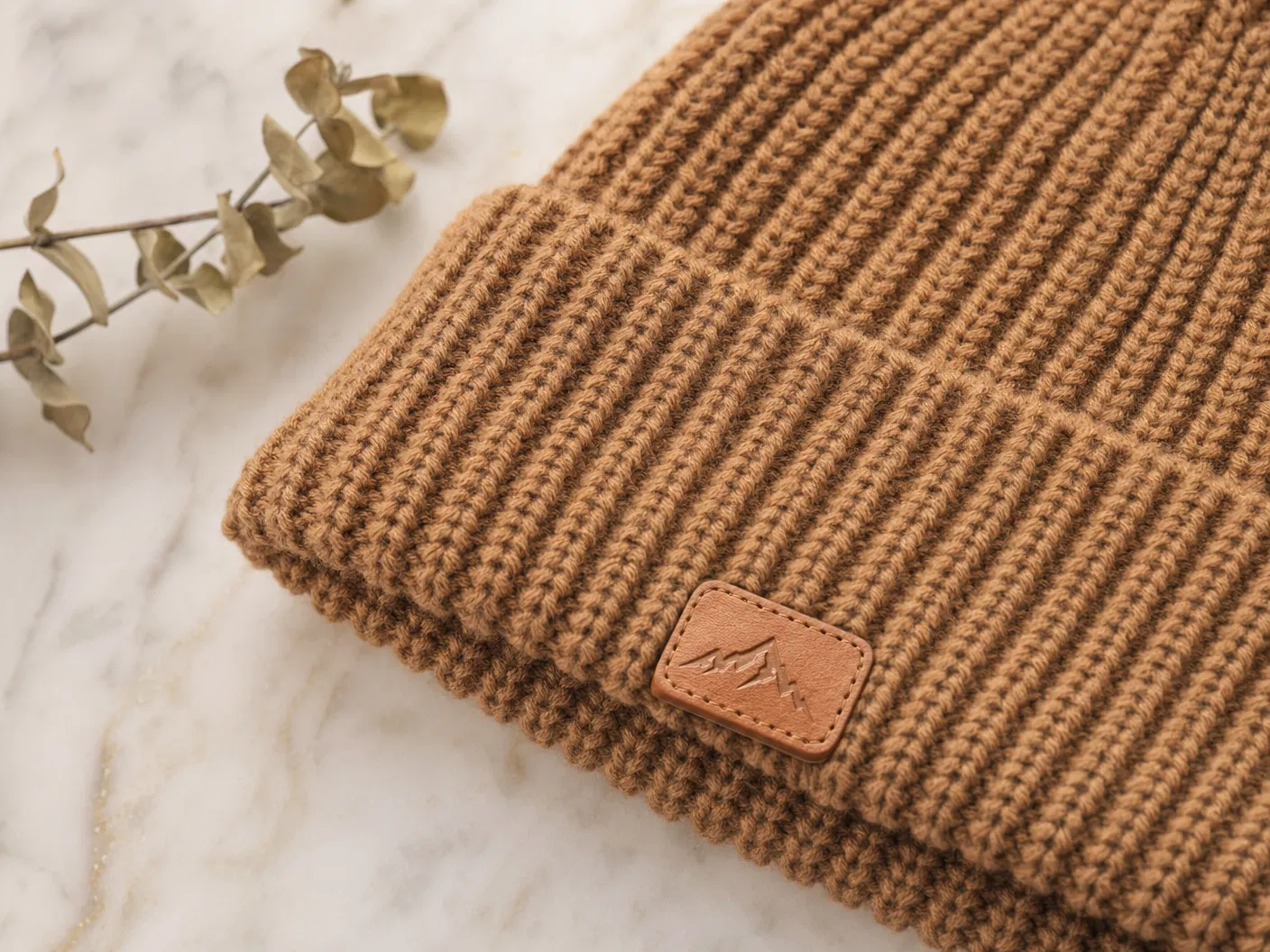 Leather patch on camel beanie