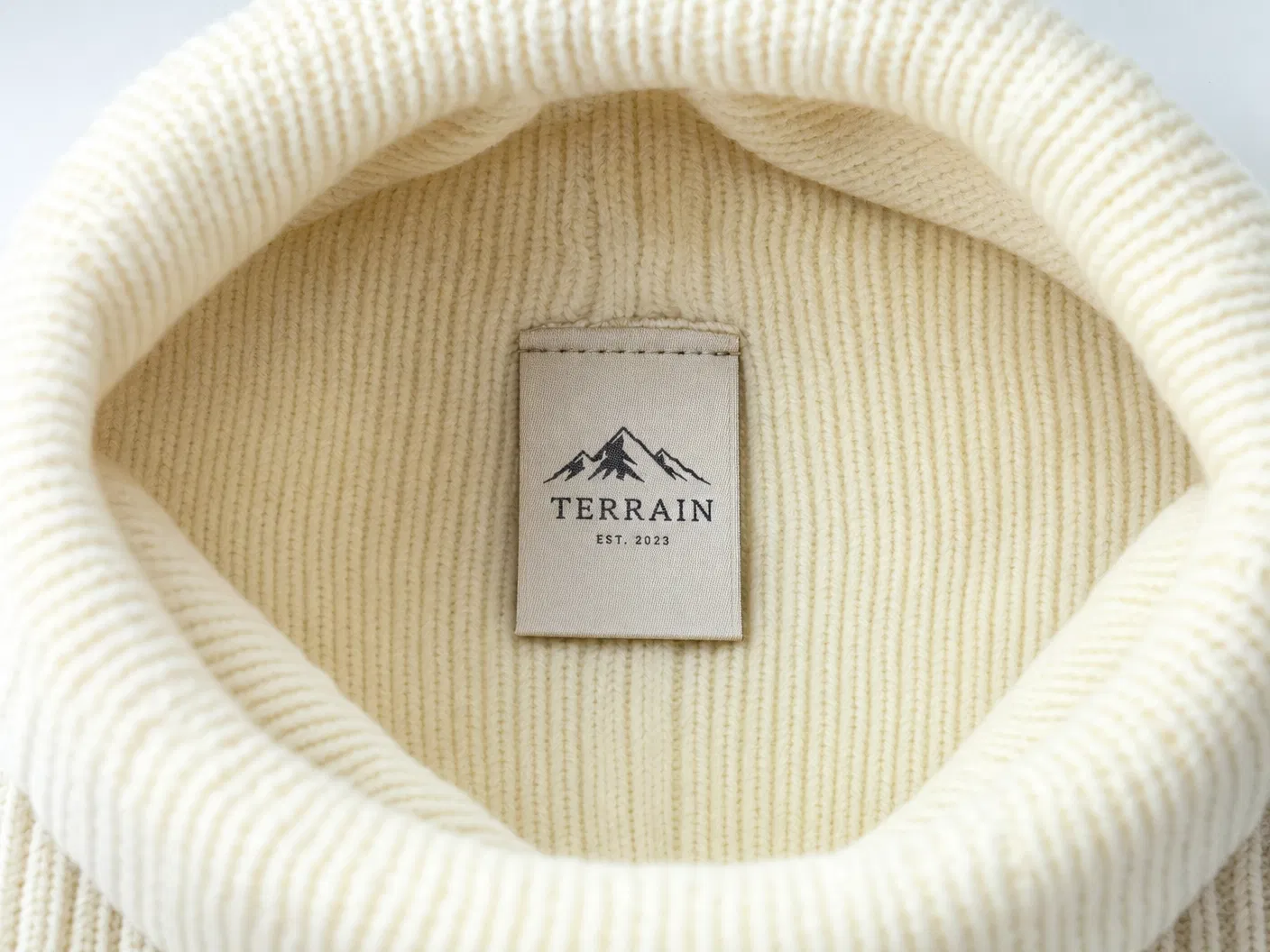 Woven brand label inside cream beanie