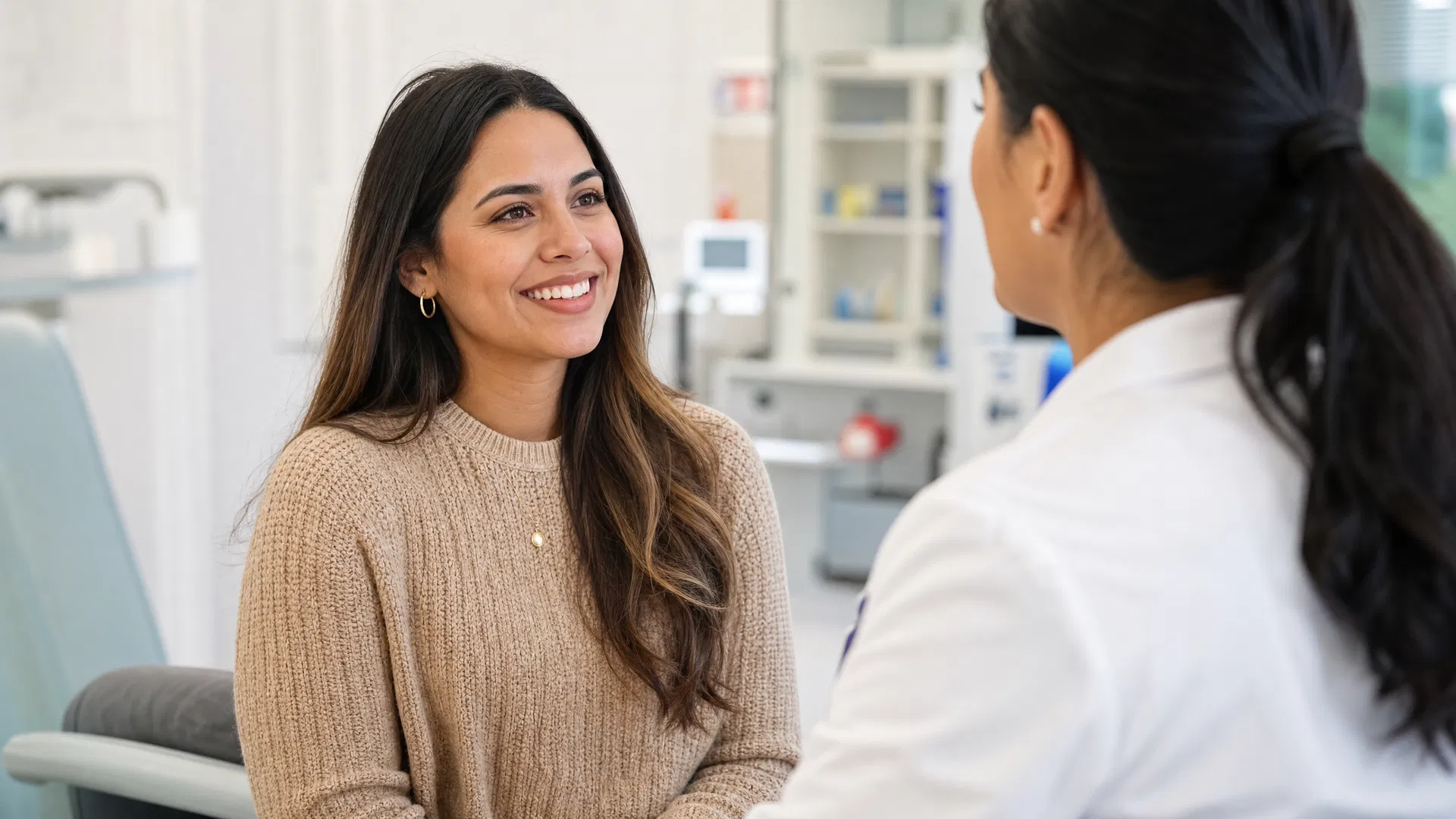 Young Hispanic woman consulting with healthcare professional