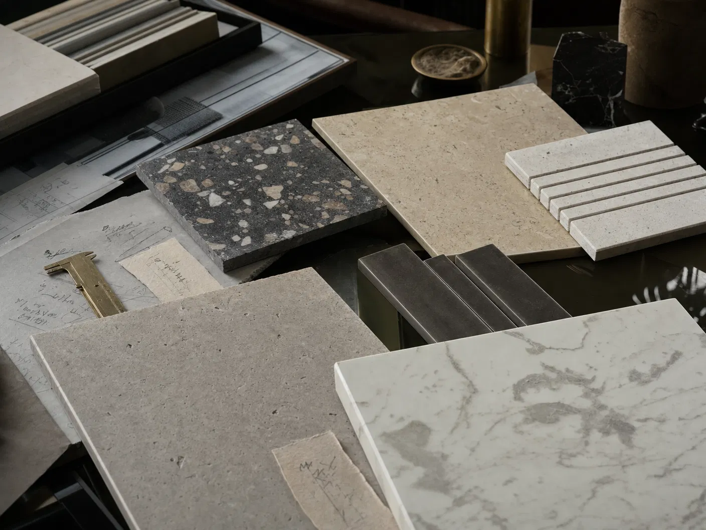Curated premium tile sample library on an architectural studio table