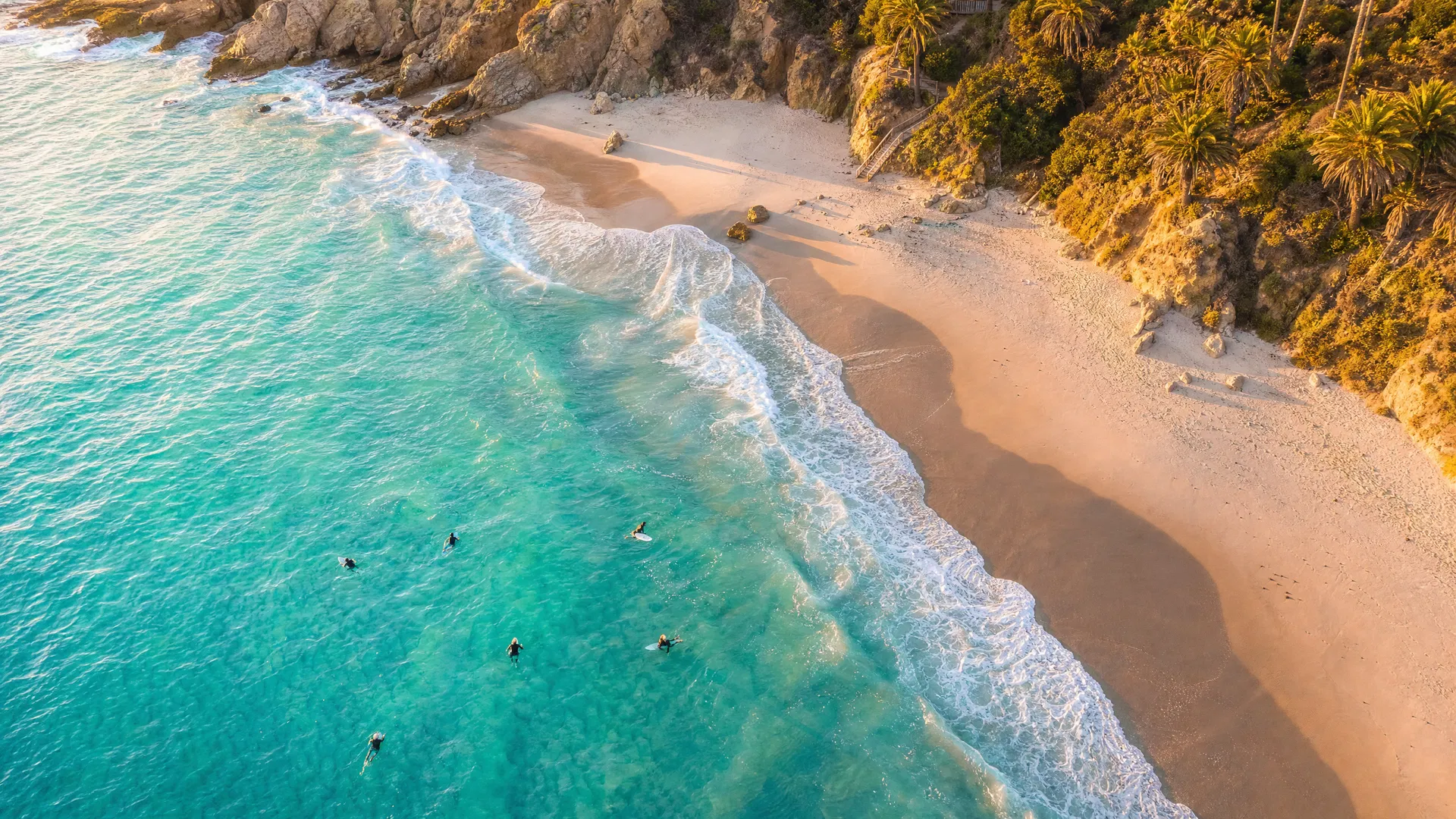 Aerial view of surfers in turquoise water