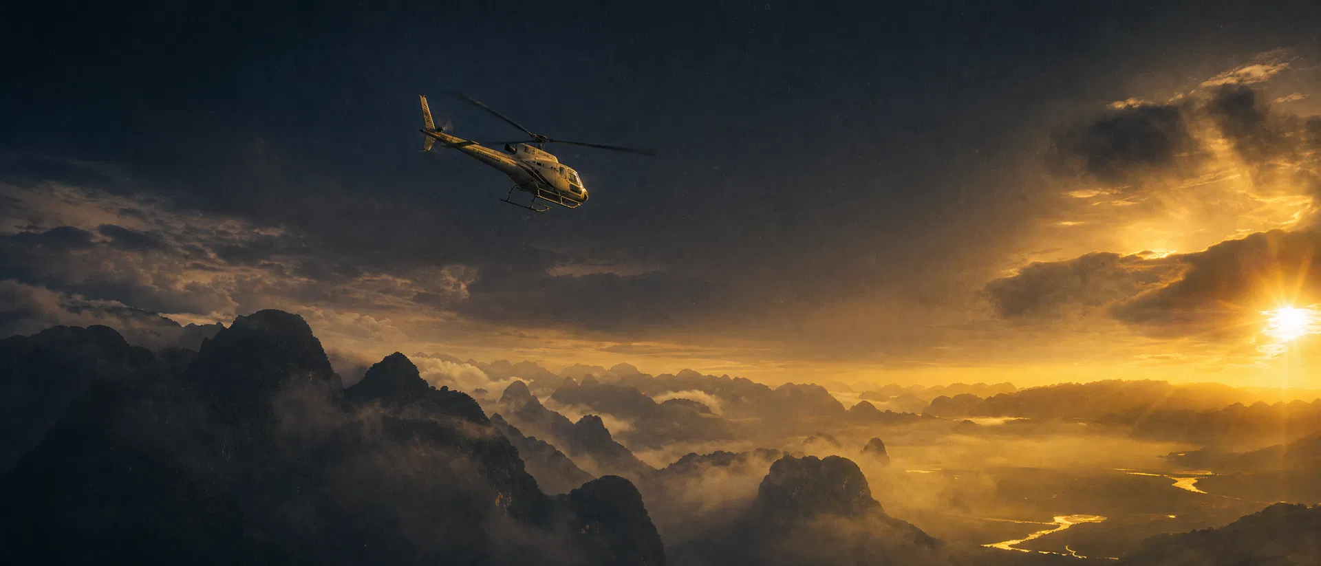 Helicopter over Southeast Asian mountains at dusk