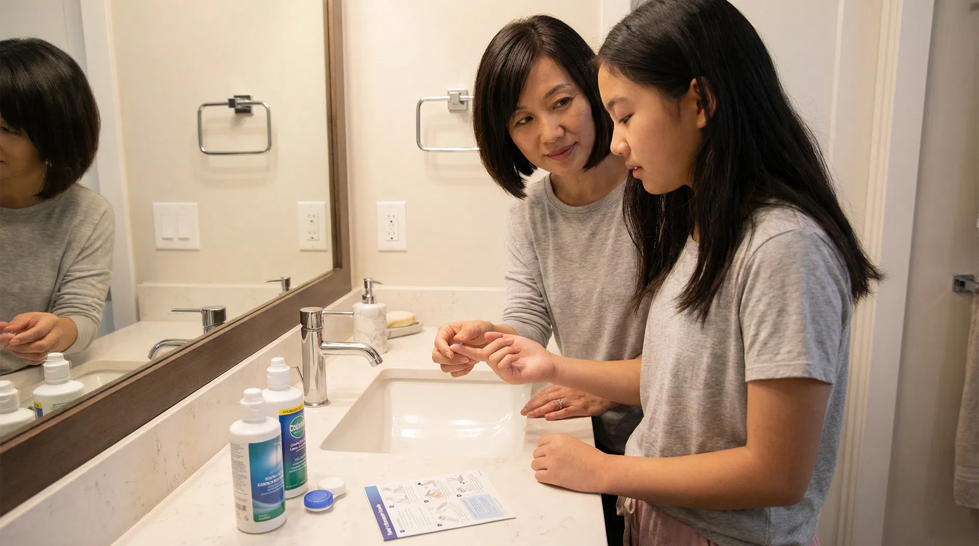 A teenager learning how to properly clean their ortho-k lenses from an optometrist.