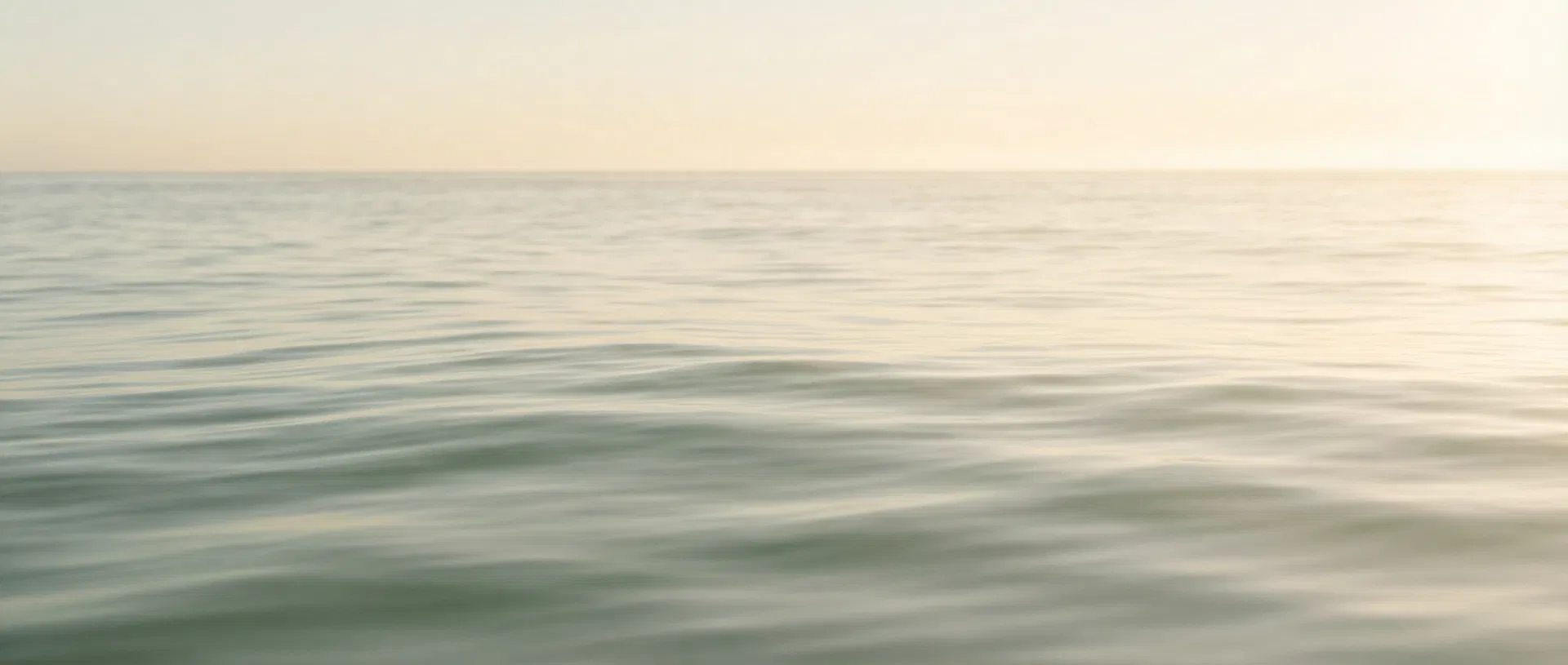 Calm ocean waves at sunrise