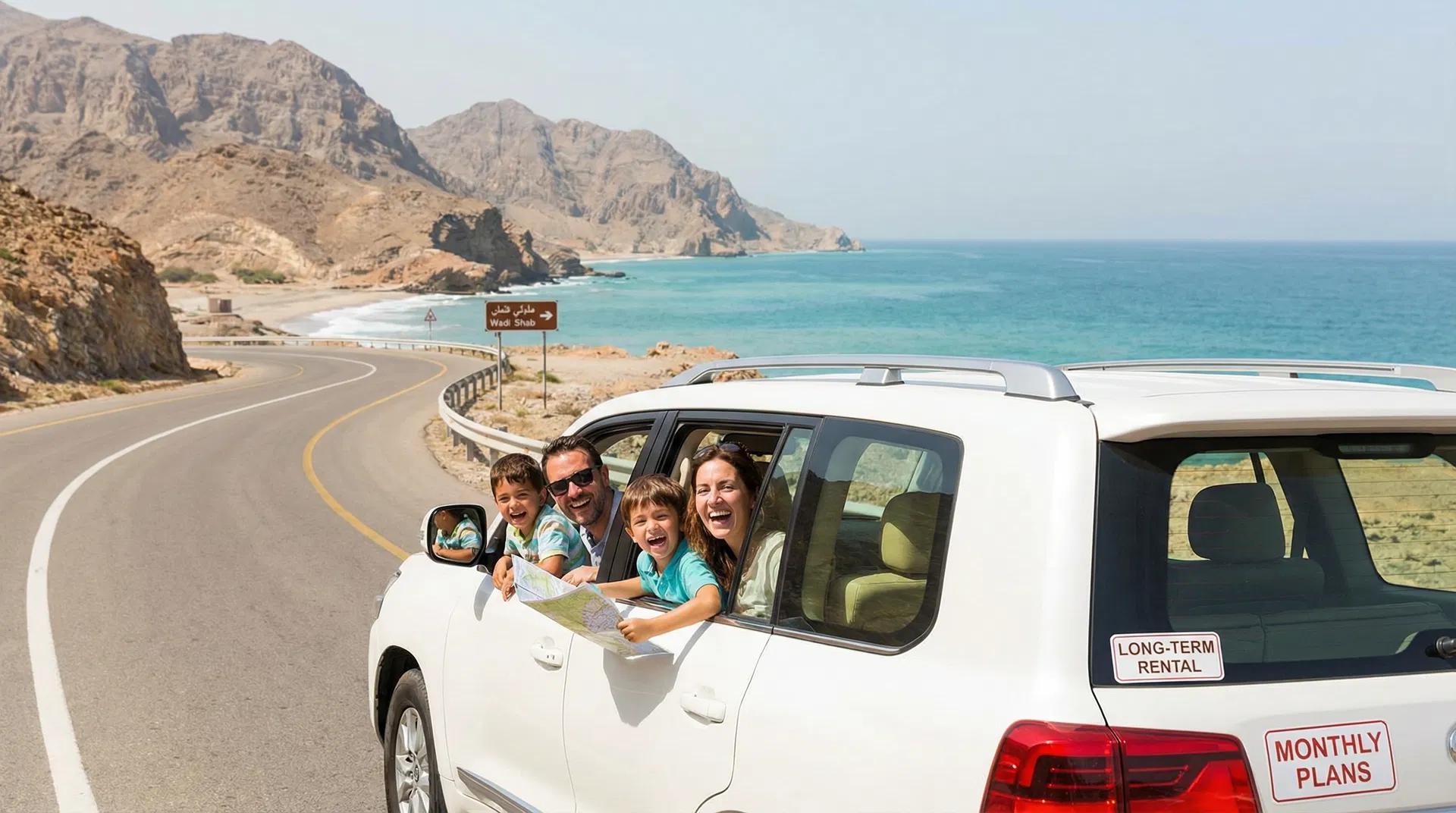 Long-term car rental in Muscat Oman - family enjoying rental car on scenic Oman road with mountains and coast visible