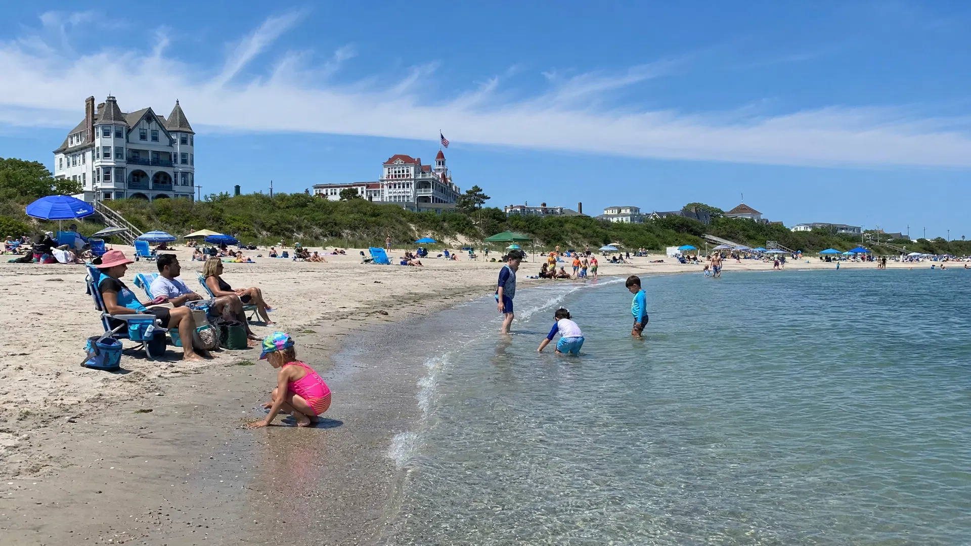 Families enjoying the calm waters at Cove Beach, Cape May