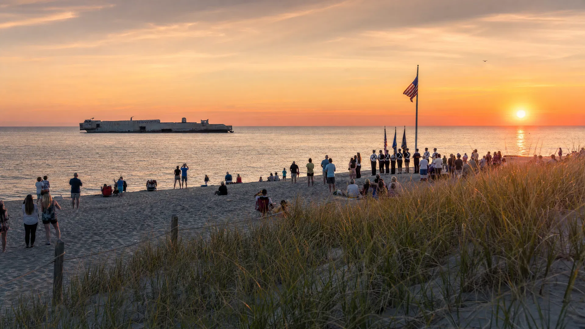 The nightly flag ceremony at Sunset Beach with the SS Atlantus wreck visible offshore