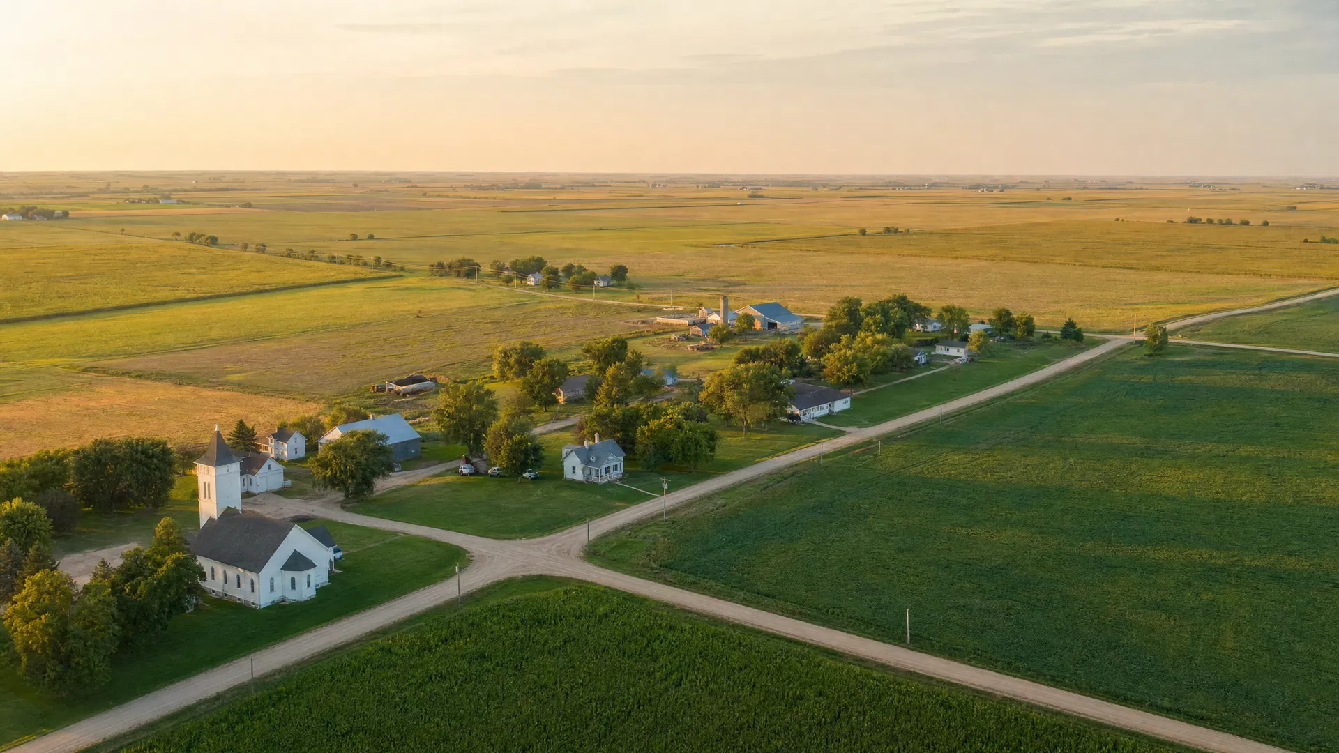 Newkirk, Iowa tiny community with white church along a gravel road surrounded by Iowa prairie